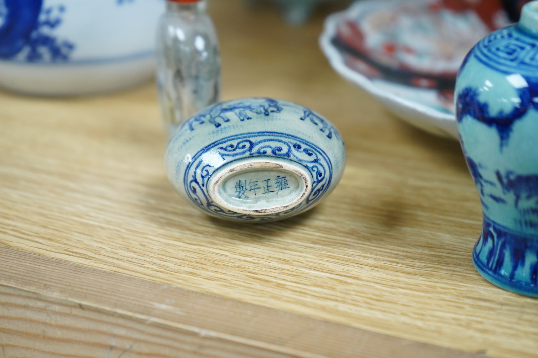 A collection of Asian ceramics to include an inside painted glass snuff bottle, pink ground dish and an Imari dish